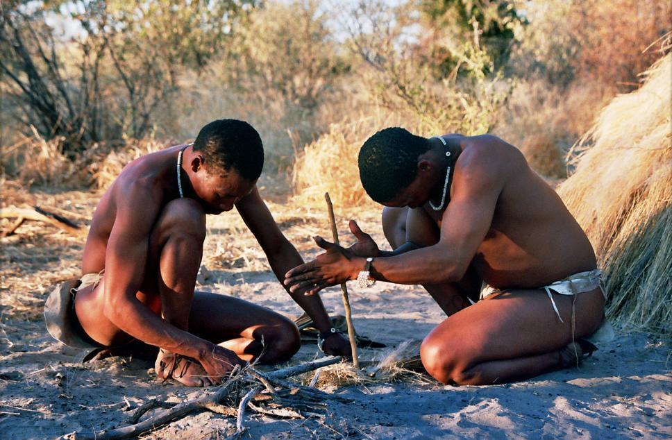 San men demonstrate traditioal techniques to start fire