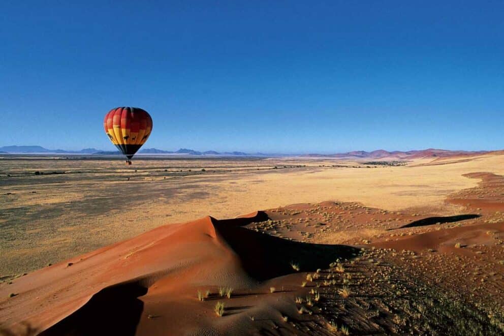 Hot air balloon flying above the desert in Namibia.