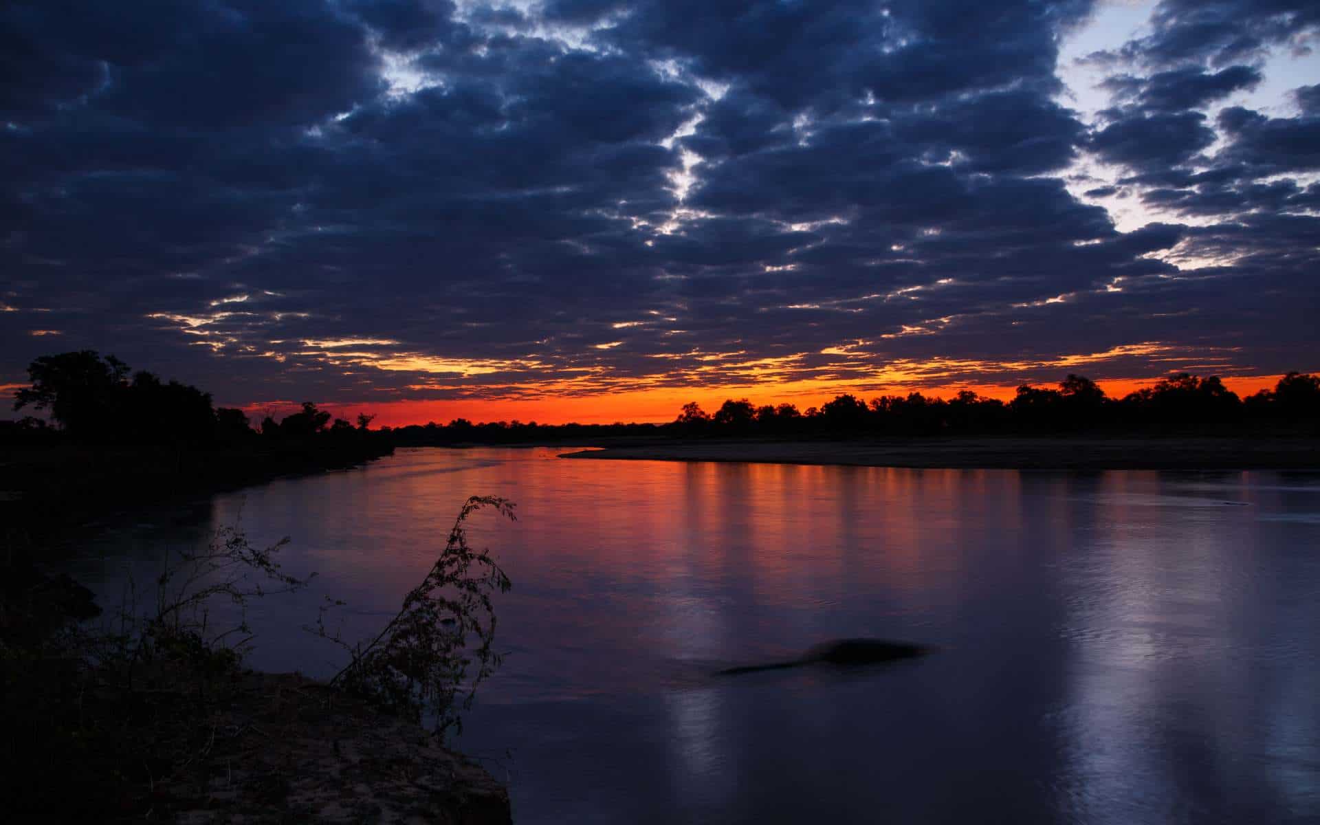 View of sunset over body of water in Zambia