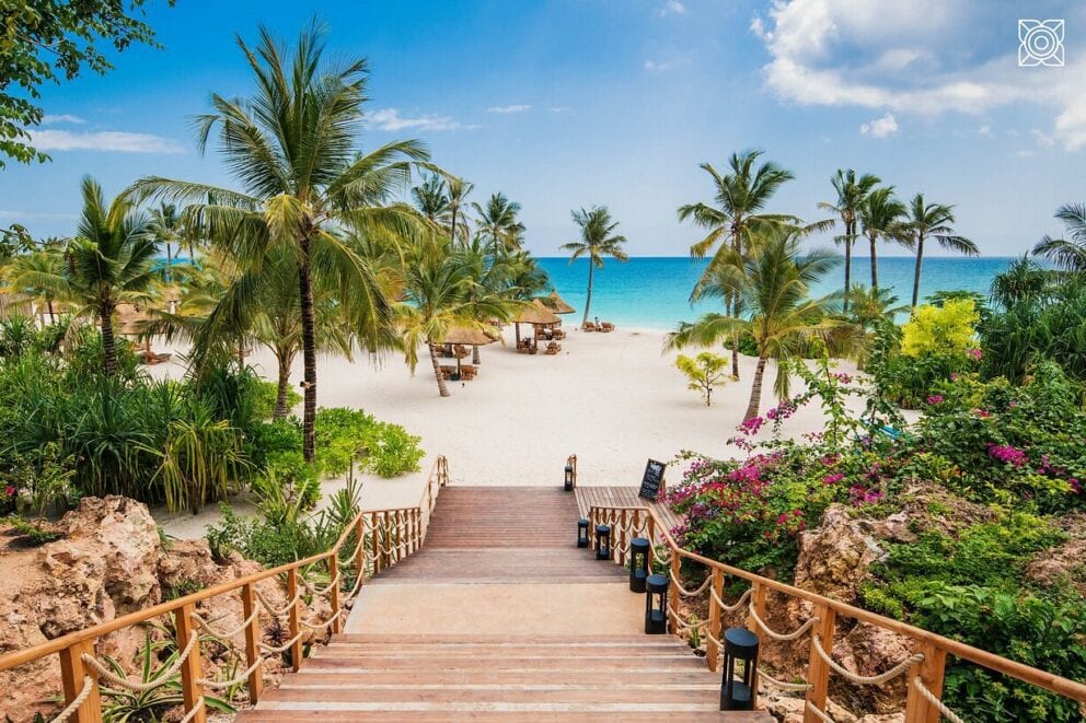 Wooden walkway to the tropical beach at Zuri Zanzibar on an African beach holiday