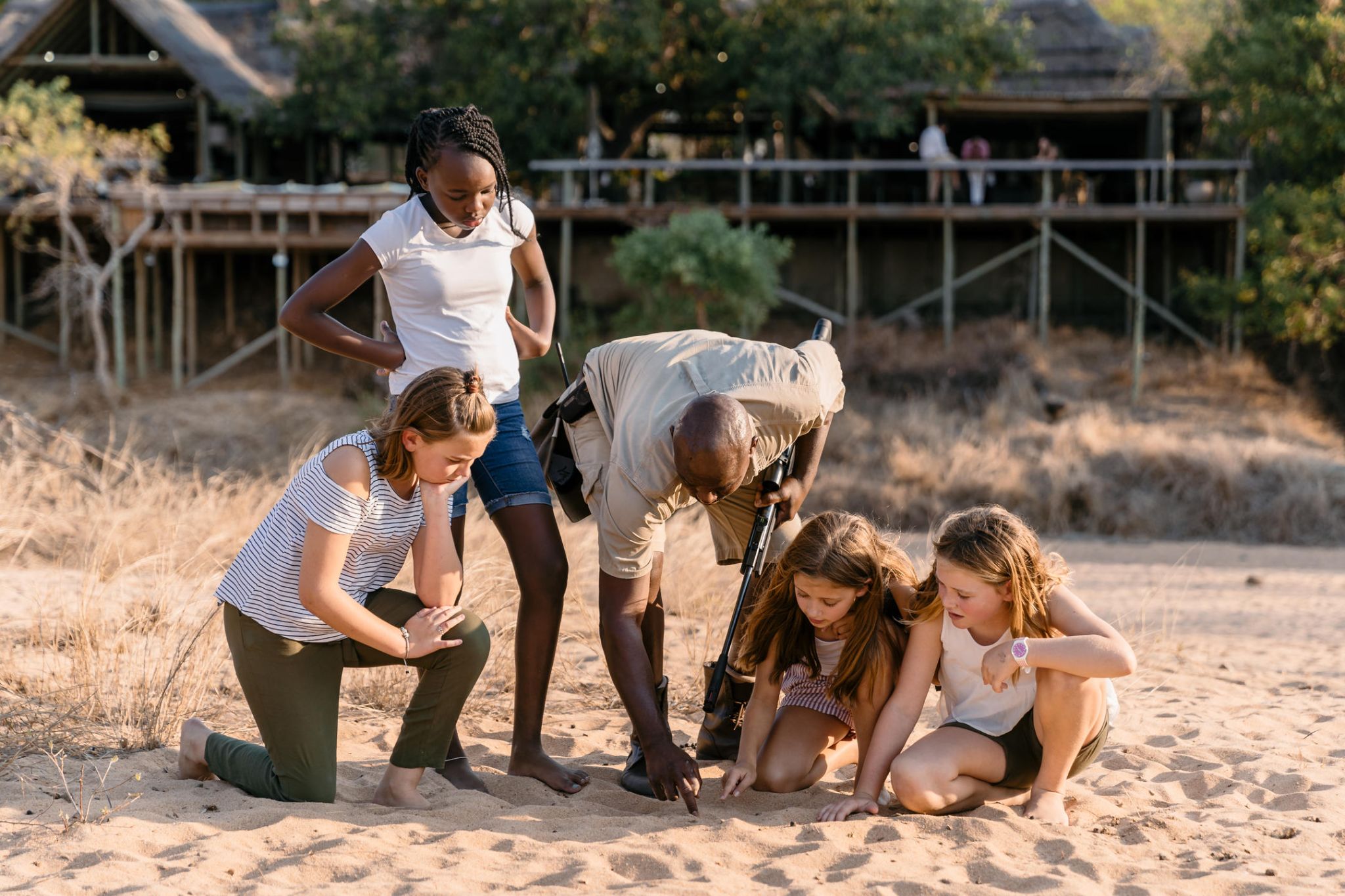 Guides teaching children on Safari