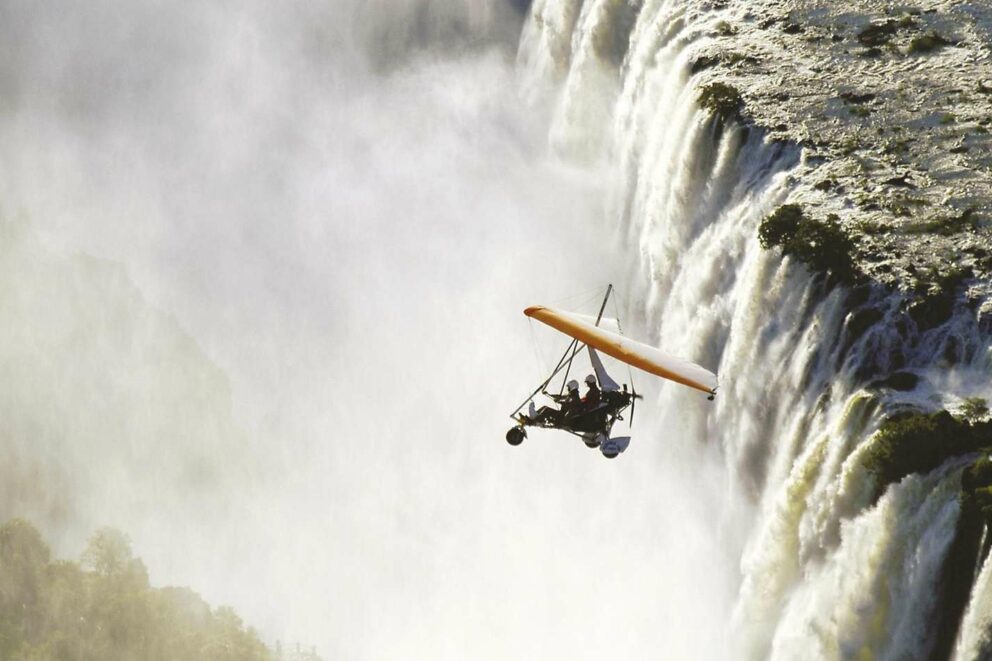 Microlight flies above Victoria Falls.