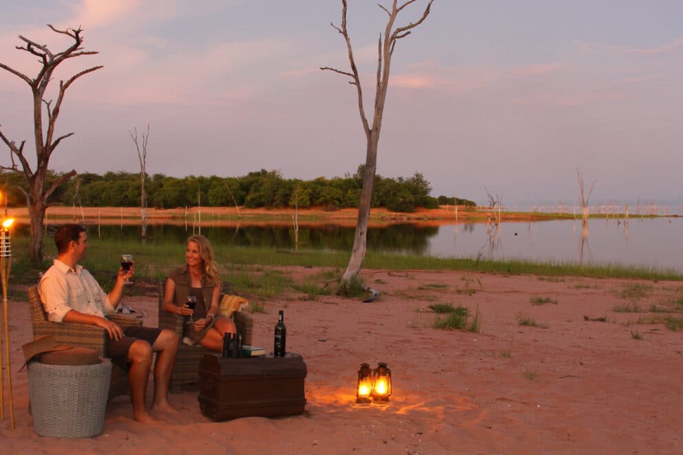 Couple on honeymoon enjoying sundowner drinks at Lake Kariba in ZImbabwe | Photo credit: Changa Safari Camp