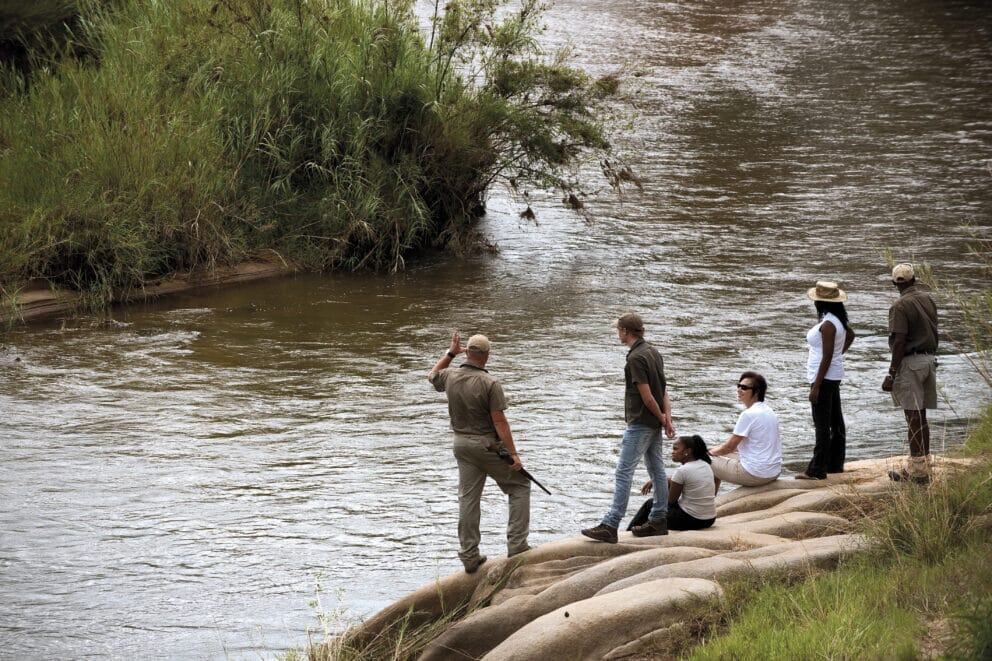 Safari-goers by the Sand River in Kruger. Which is a safe place to travel to.