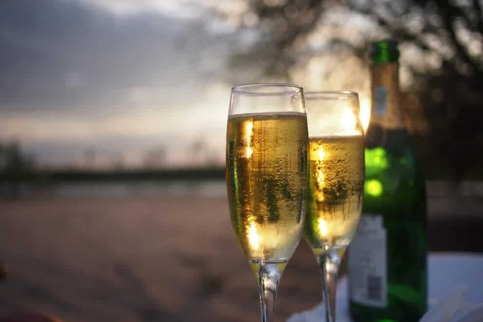 Champagne glasses and bottle on a luxury sunset safari