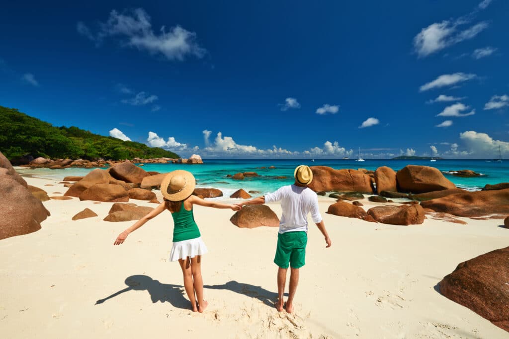 Couple having fun on a tropical beach at Seychelles