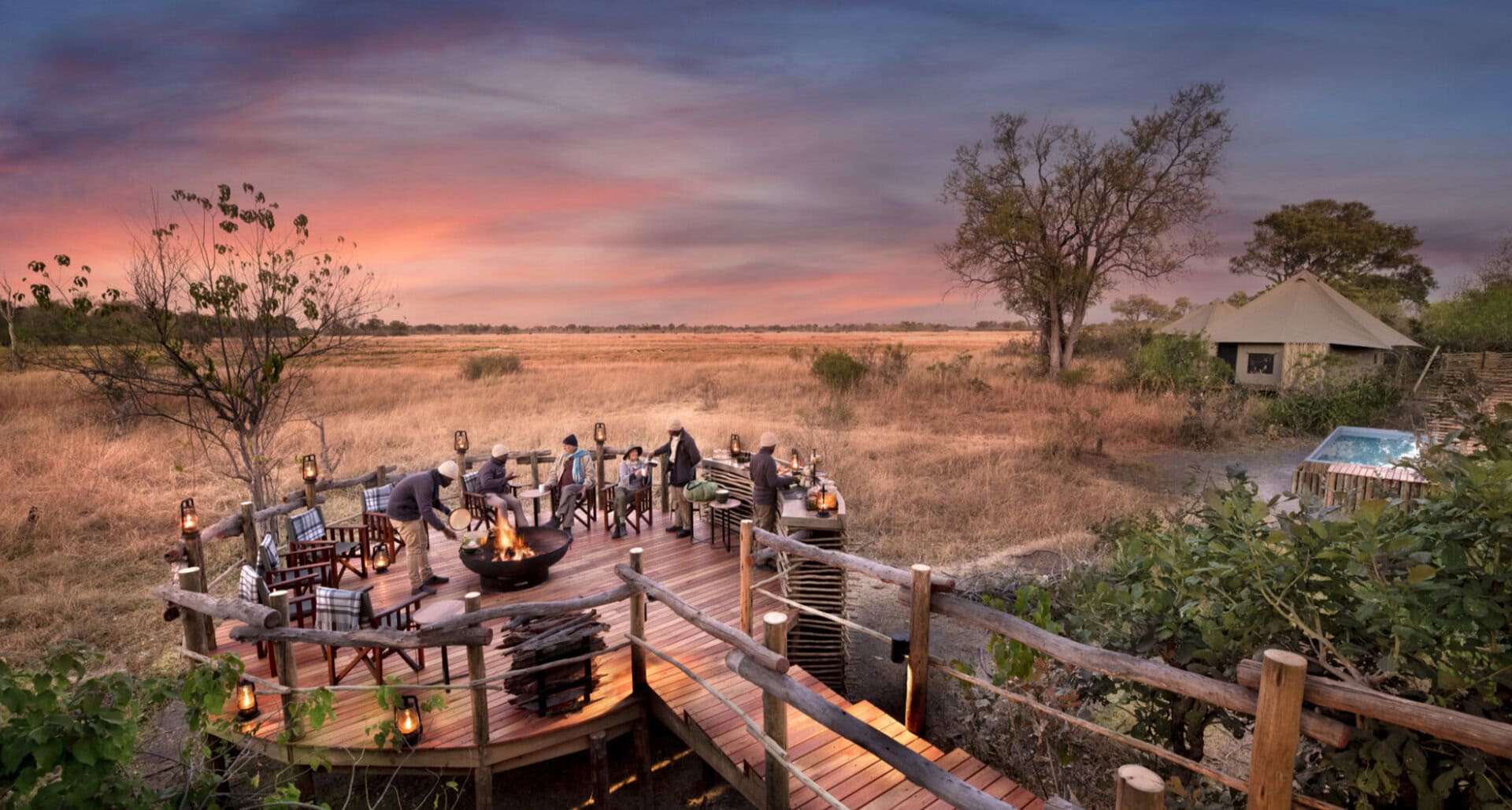 View of a outdoor fireplace and seating area on a deck 