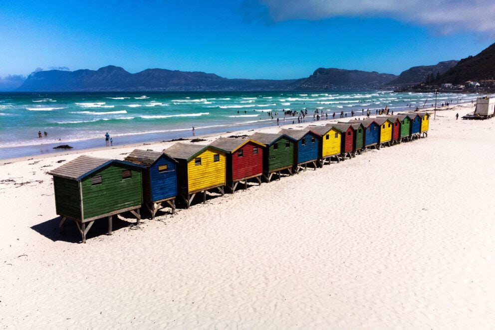 A row of colorful beach houses in Muizenberg Beach, Cape Town.