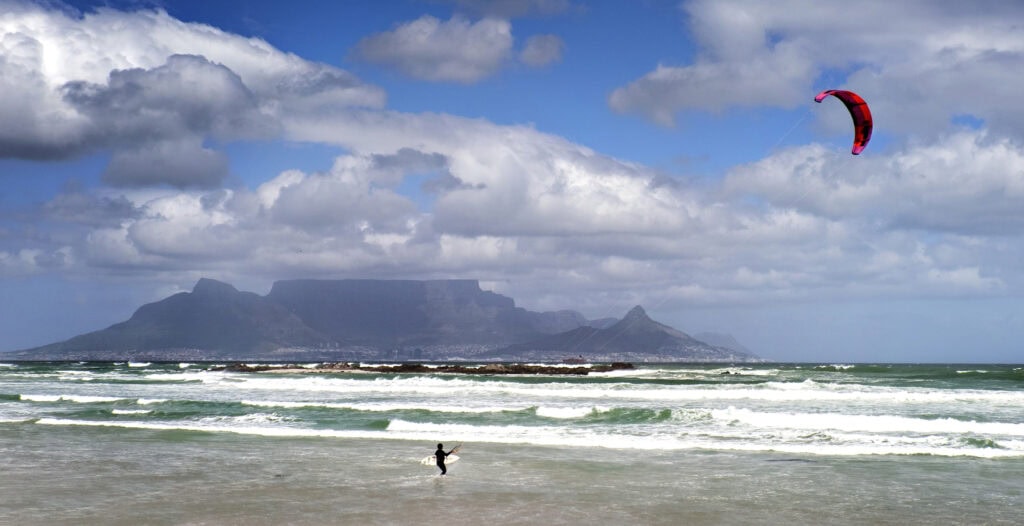 Windy day at Bloubergstrand beach overlooking Table Mountain and the city of Cape Town