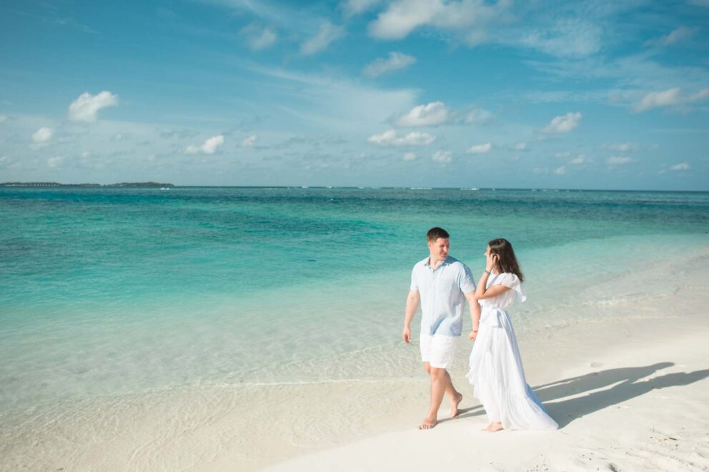 Heterosexual couple walking on a beach