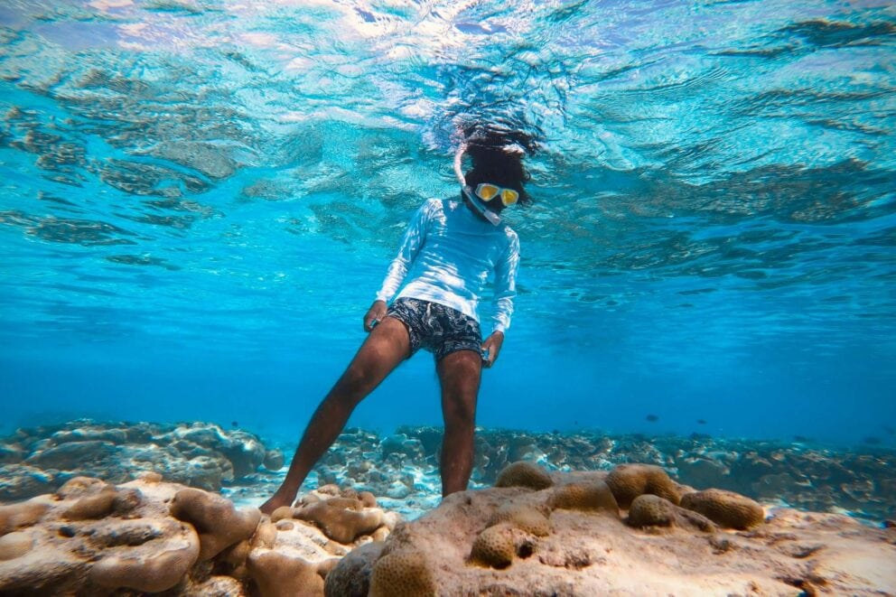 View of a man snorkeling underwater in a tropical reef