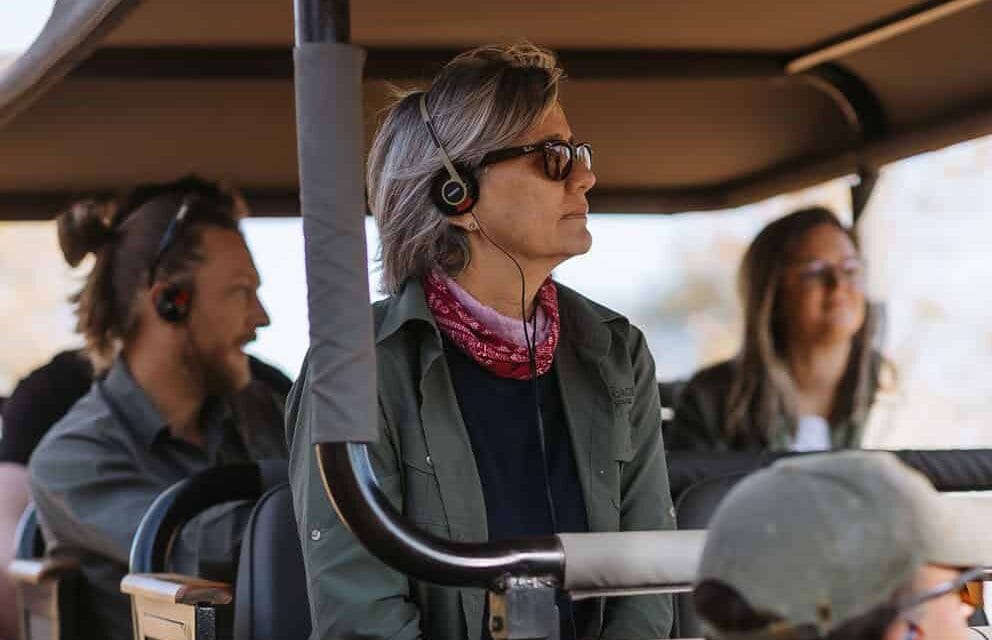 Three people in a safari vehicle on a sound safari with The Outpost in Kruger National Park