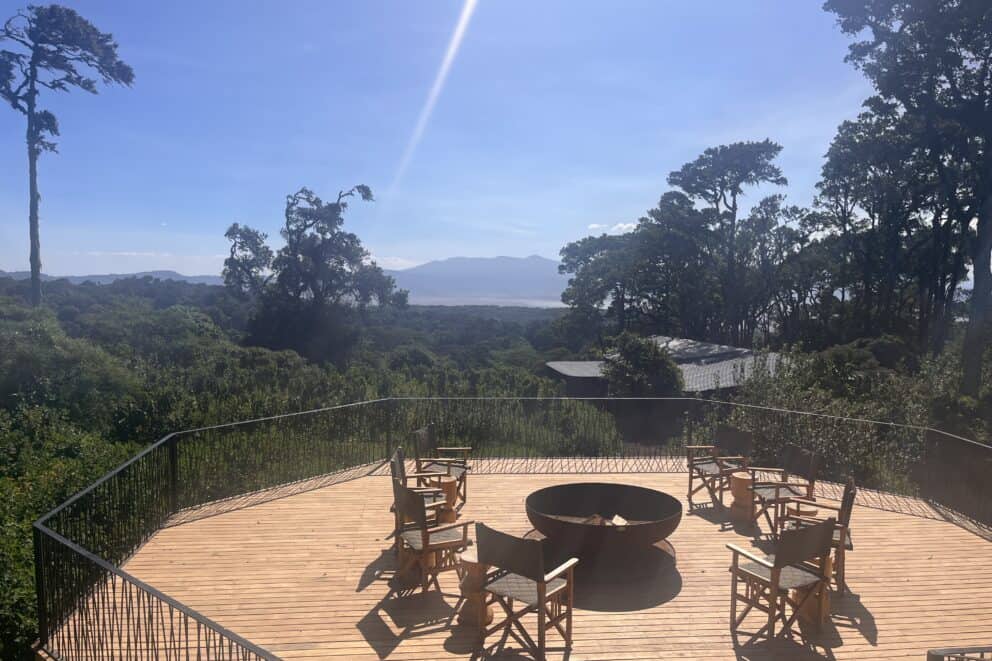 Elevated deck with chairs around the boma under the clear blue African sky at Lemala Osonjoi Lodge, Tanzania.