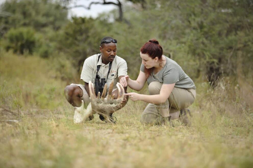 Guide with a tourist on a walking safari in Tanzania | Photo credit: Roho Ya Selous