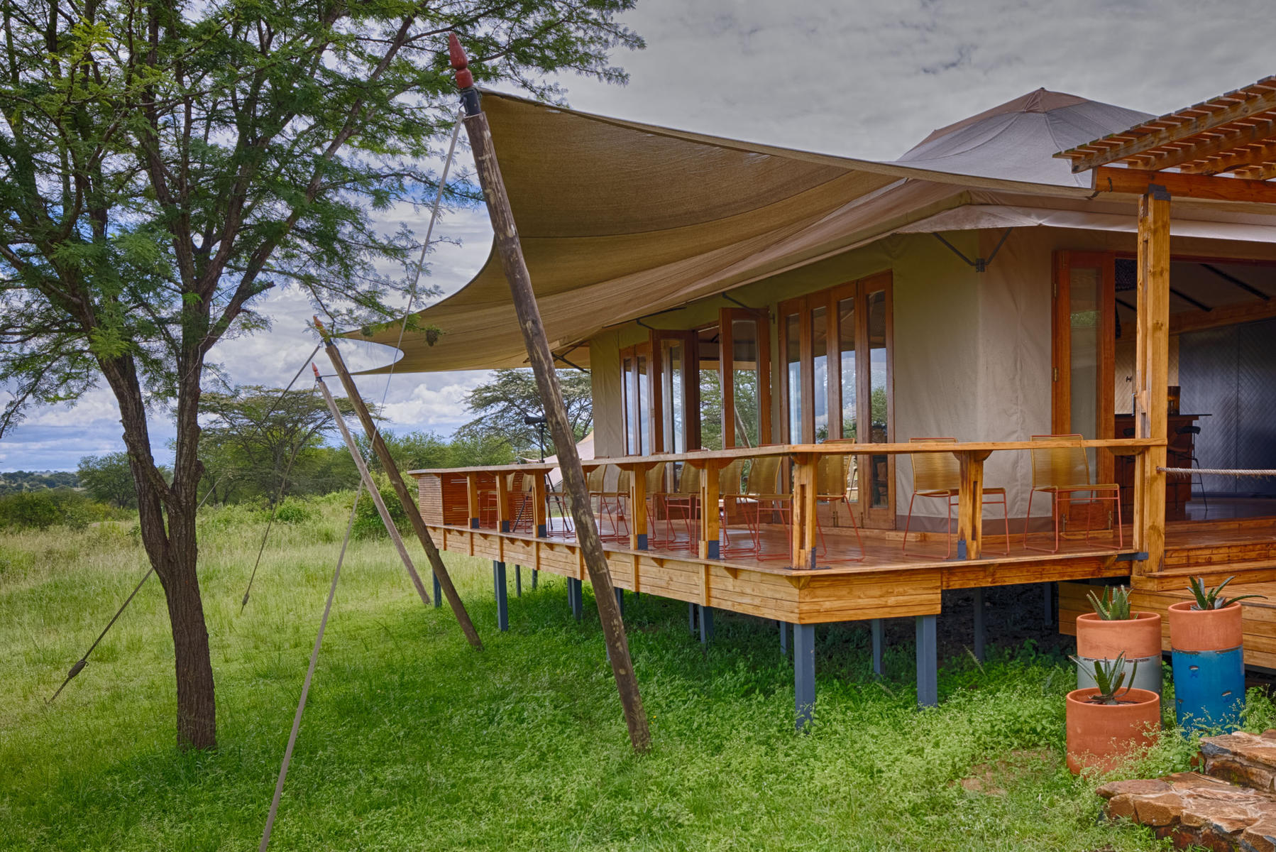 Deck leading from the bar area at Asilia Africa Sayari, a luxury safari lodge.