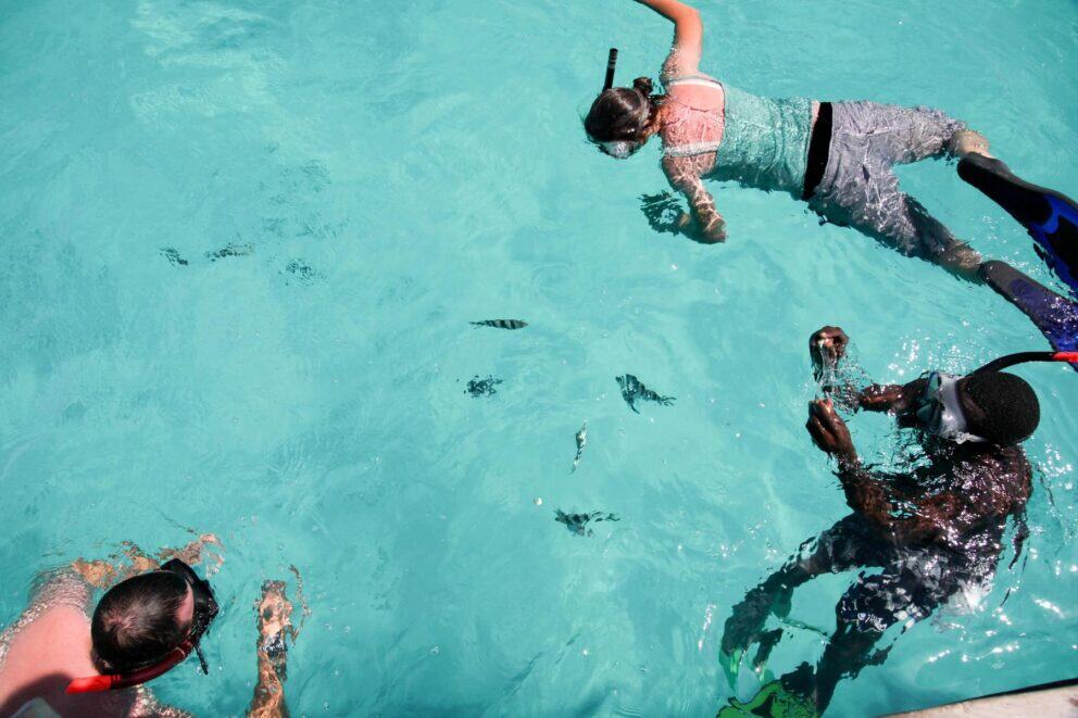 Tourists snorkeling in the Mnembe Atoll, Zanzibar.