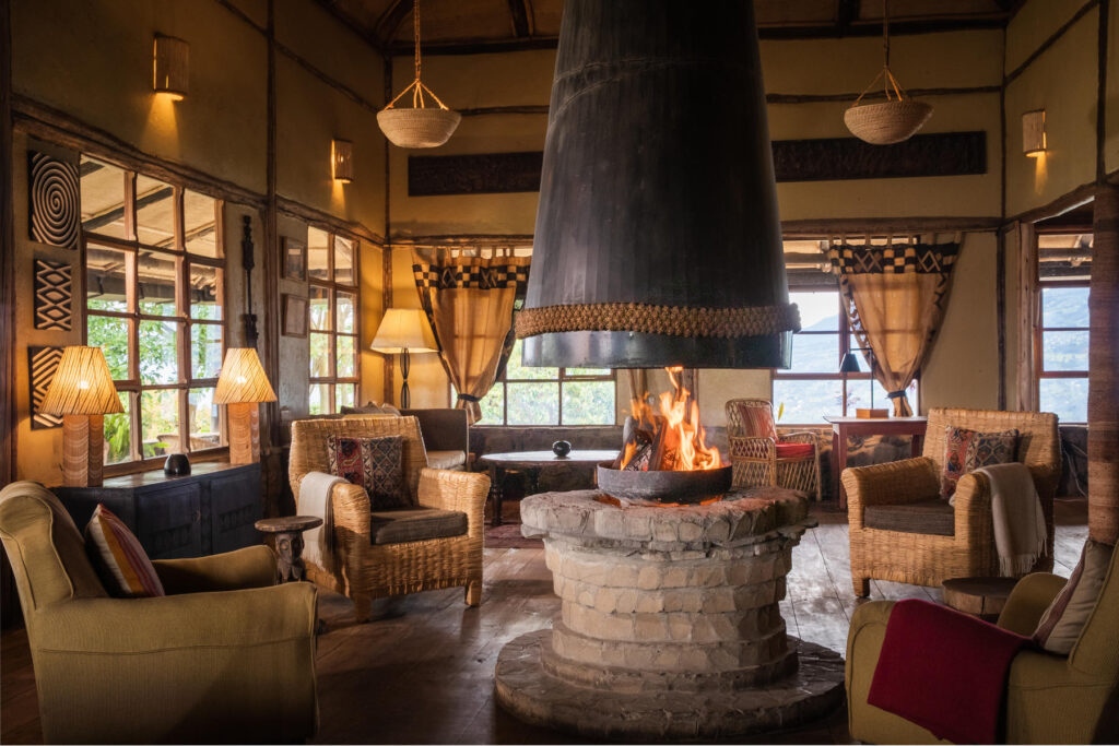 Fireplace in the centre of the room with armchairs all around