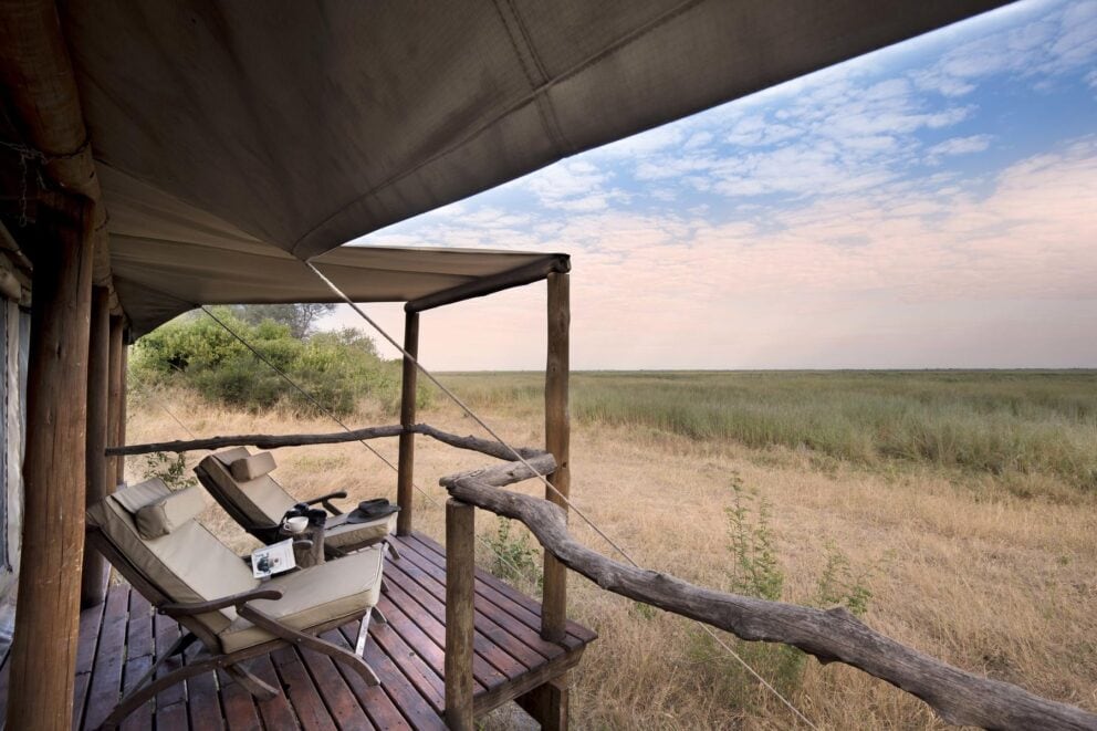 two deck chairs overlooking the bush on a deck 