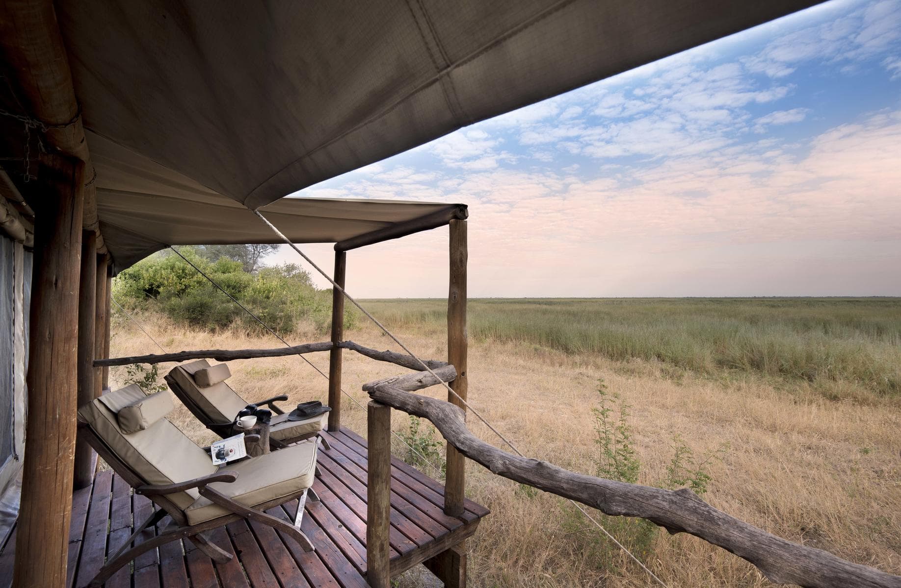 two deck chairs overlooking the bush on a deck 