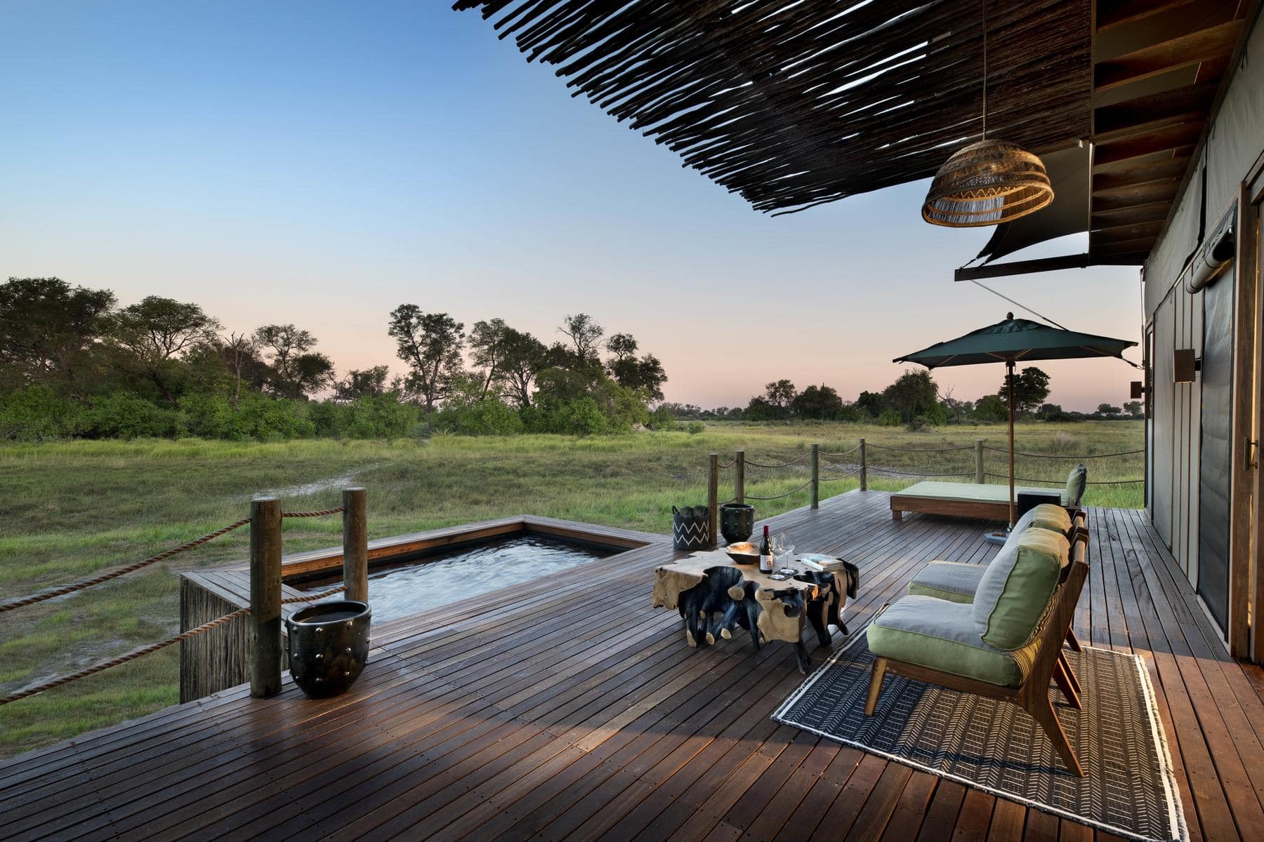 View of a private plunge pool on the deck of a safari camp. 