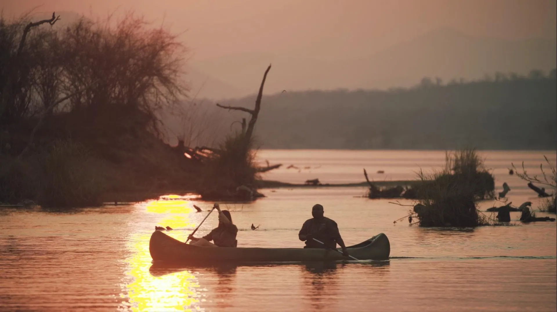 Canoeing suring sunset